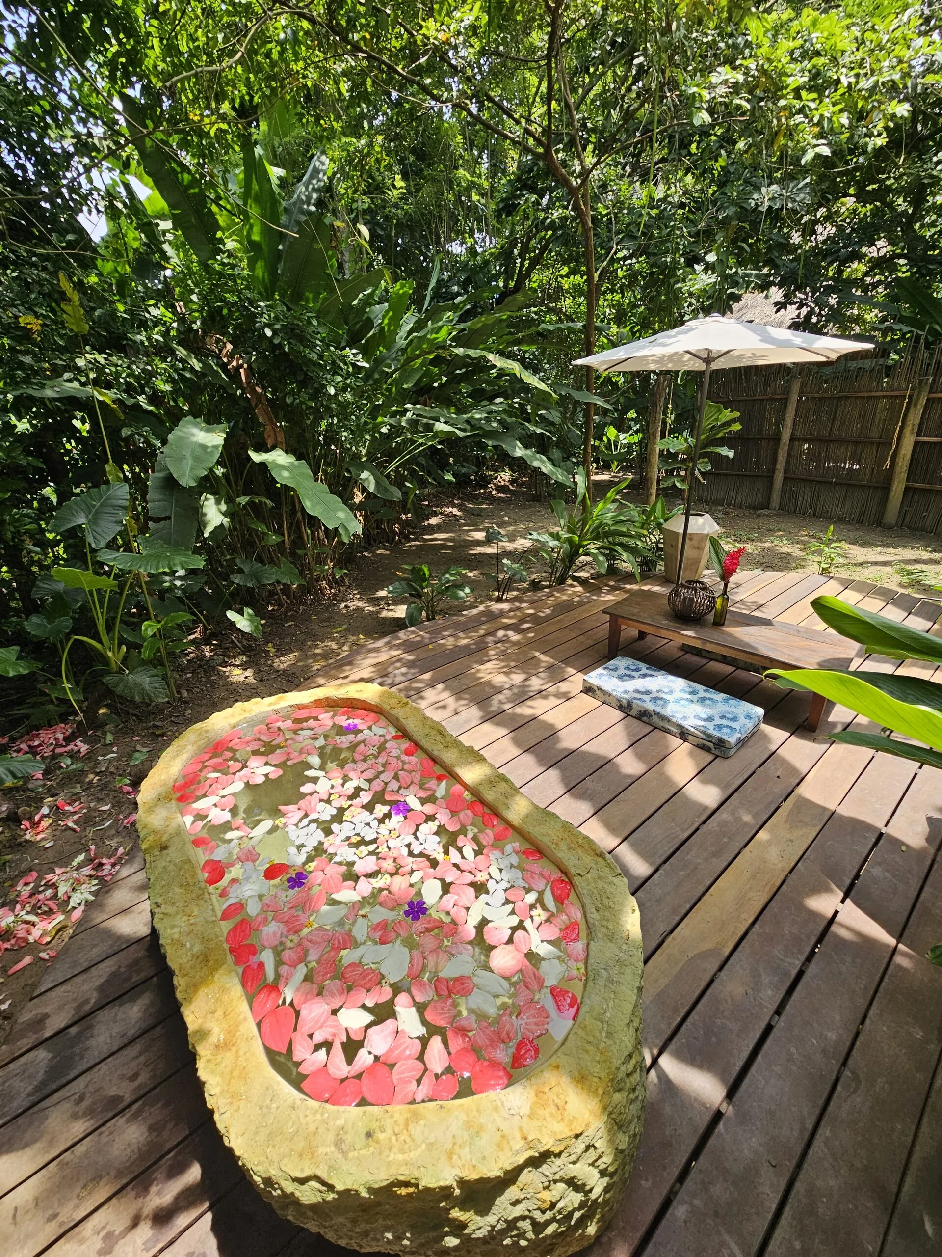 The stone tub with petals on the deck