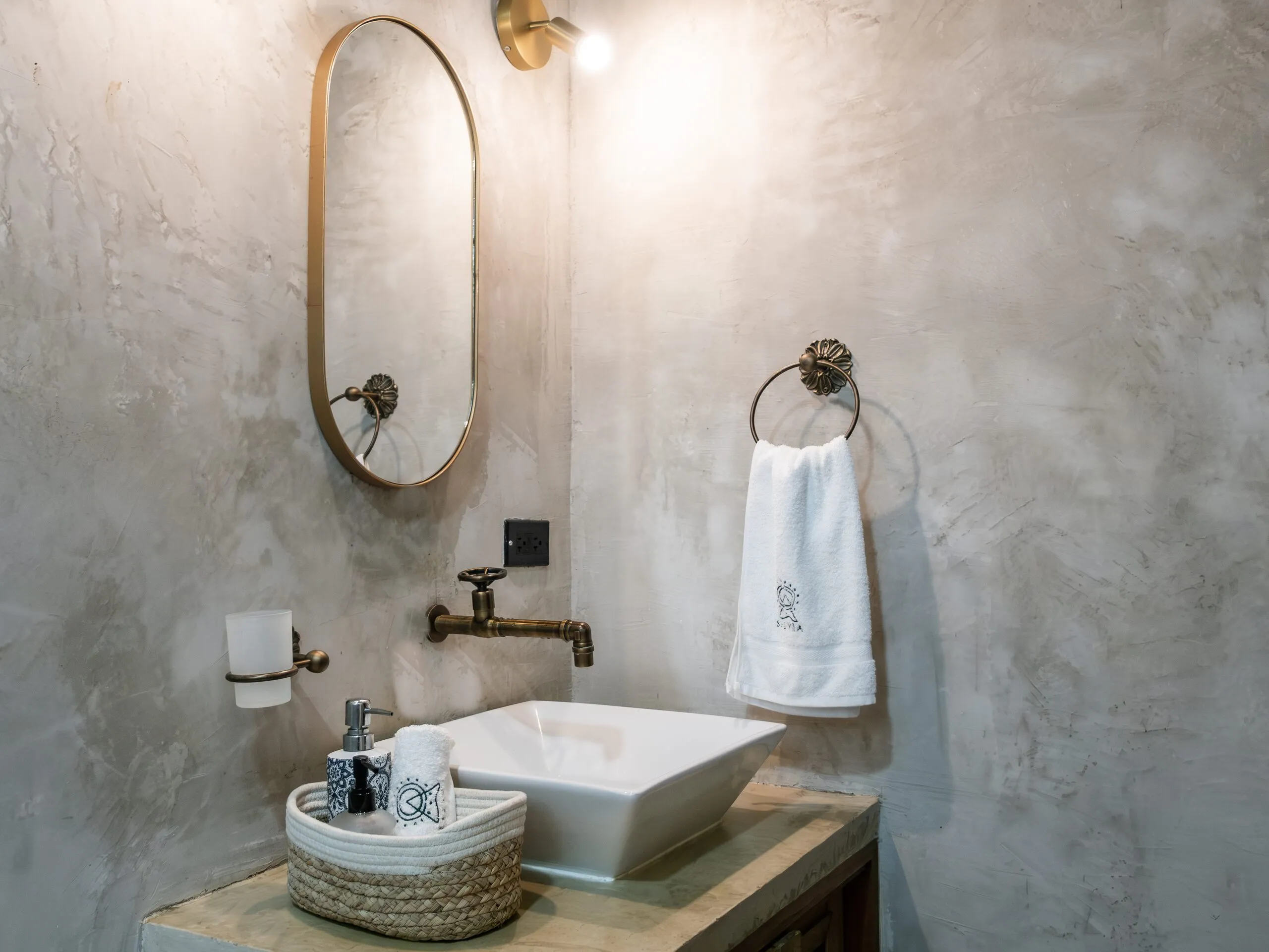 Concrete sink and golden mirror