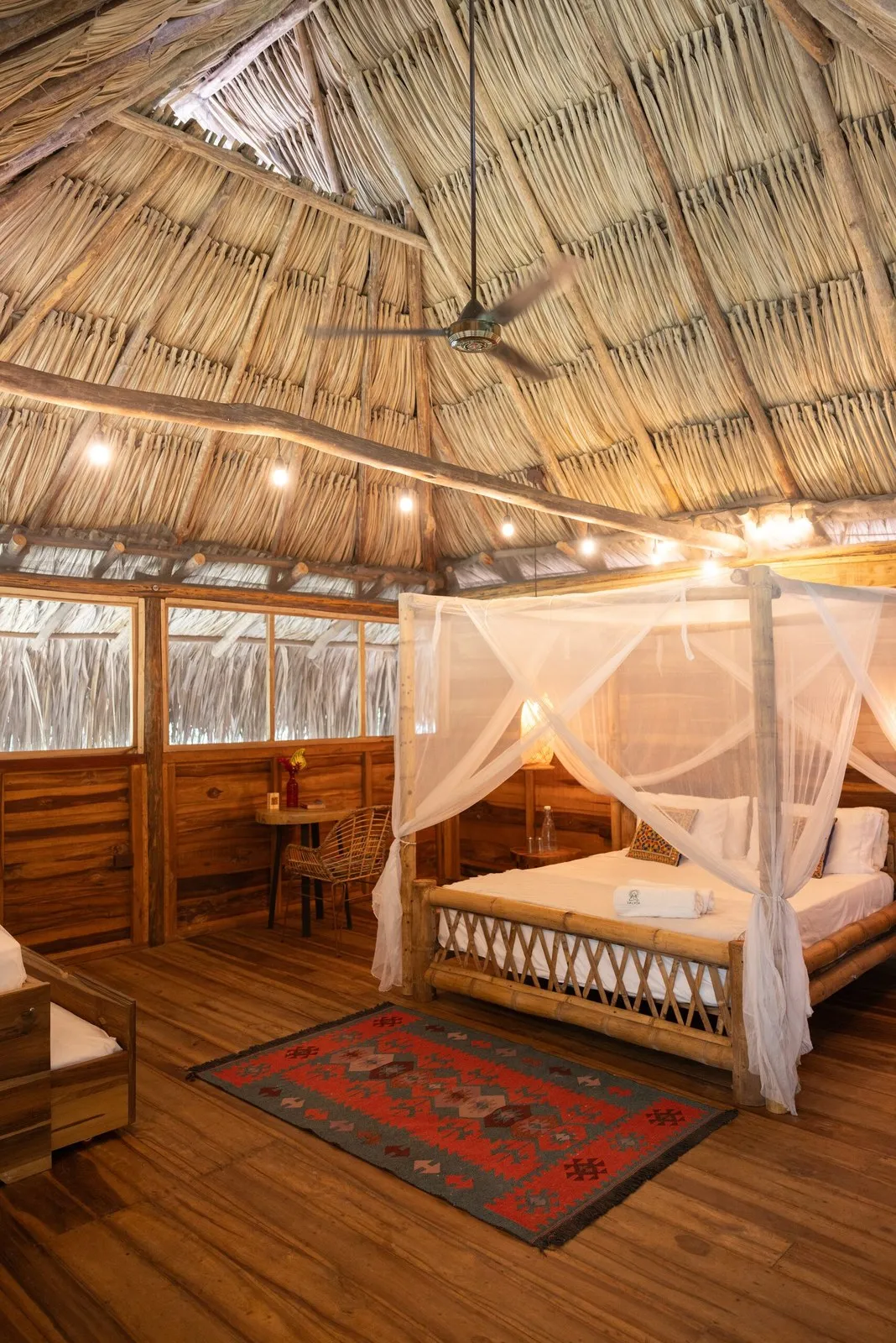 Sativa: canopy bed under a palm roof
