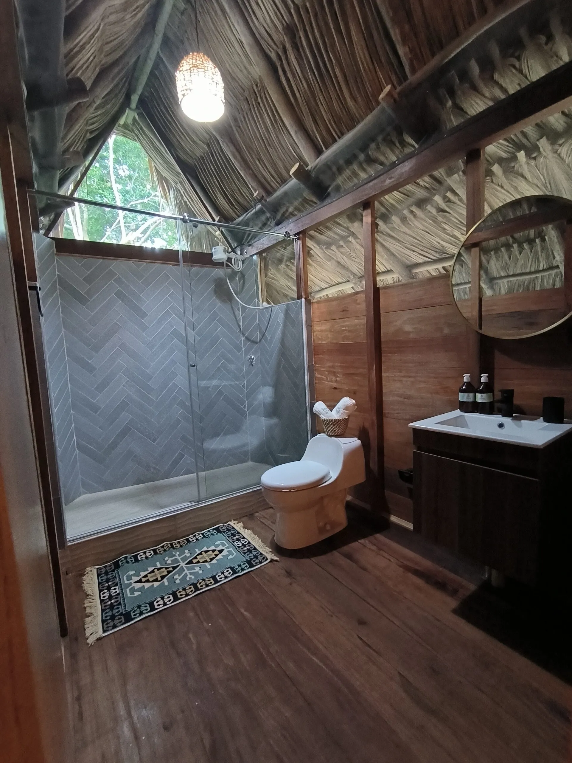Wooden bathroom with a glass shower