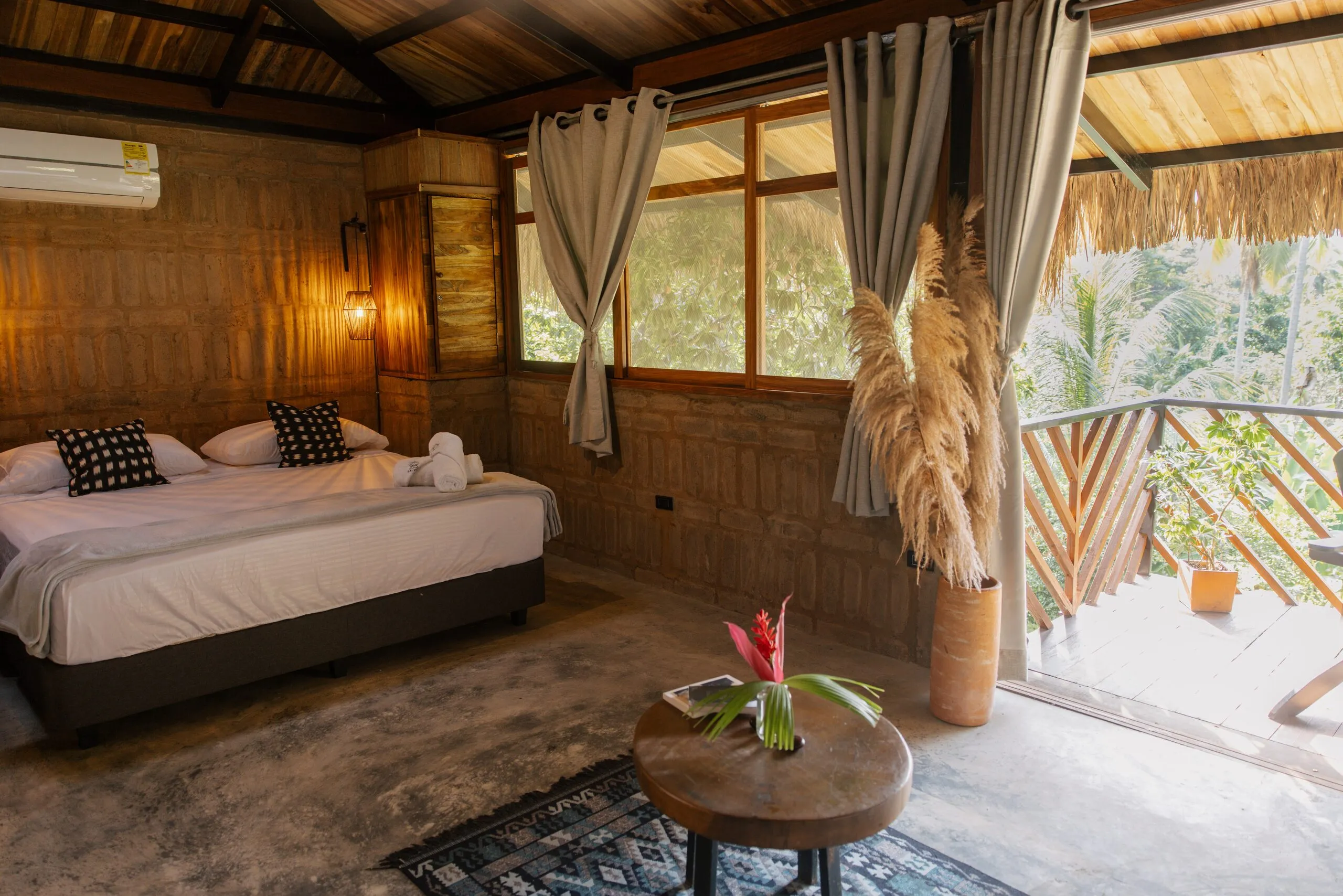 Bed and the door open to the balcony